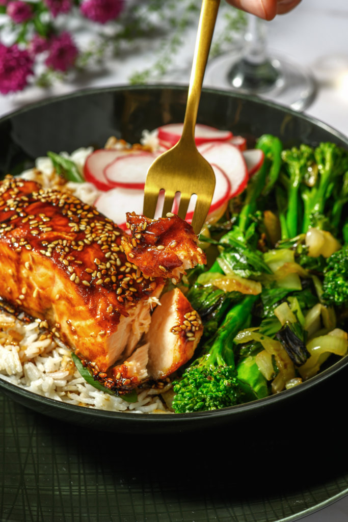 Sweet and Spicy Sriracha Salmon and Pak Choi Rice Bowl with Pickled Radish and Ginger and Spring Onion Rice.